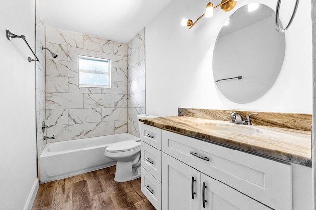 full bathroom with hardwood / wood-style floors, vanity, toilet, and tiled shower / bath combo