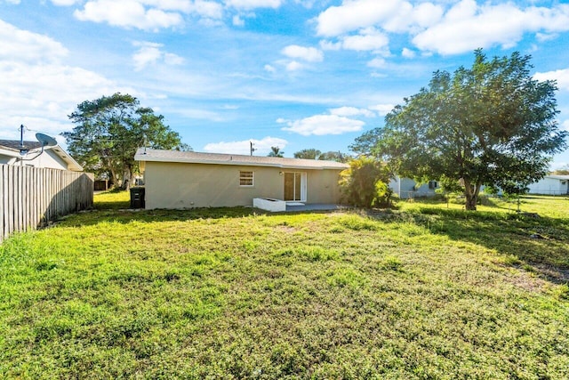 back of house with a yard