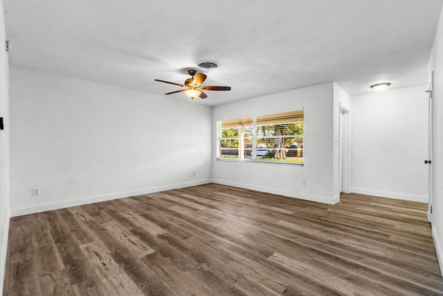 spare room featuring a textured ceiling, dark hardwood / wood-style floors, and ceiling fan