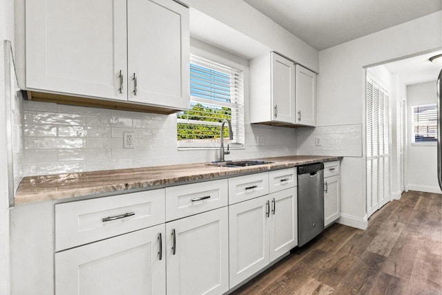 kitchen with white cabinetry, sink, stainless steel dishwasher, dark hardwood / wood-style floors, and decorative backsplash