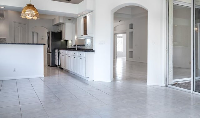 kitchen with light tile patterned floors, white cabinetry, and hanging light fixtures