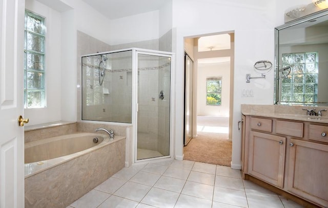 bathroom featuring tile patterned flooring, vanity, and independent shower and bath