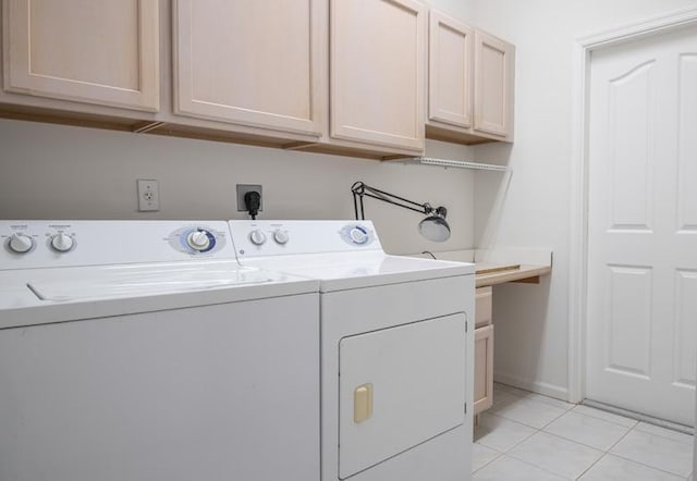 laundry room featuring light tile patterned flooring, cabinets, and independent washer and dryer