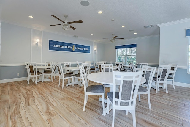 dining room with a textured ceiling, light hardwood / wood-style floors, ceiling fan, and ornamental molding