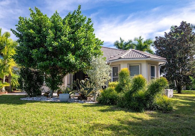 view of side of home with a yard