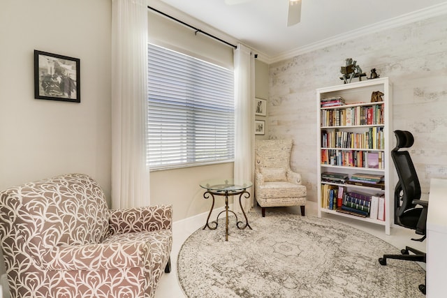 sitting room with ceiling fan and ornamental molding