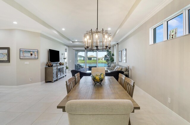 tiled dining space featuring a notable chandelier and ornamental molding