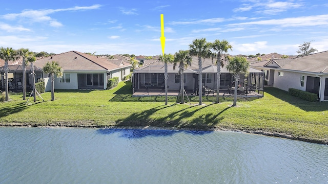 back of property featuring a yard and a water view