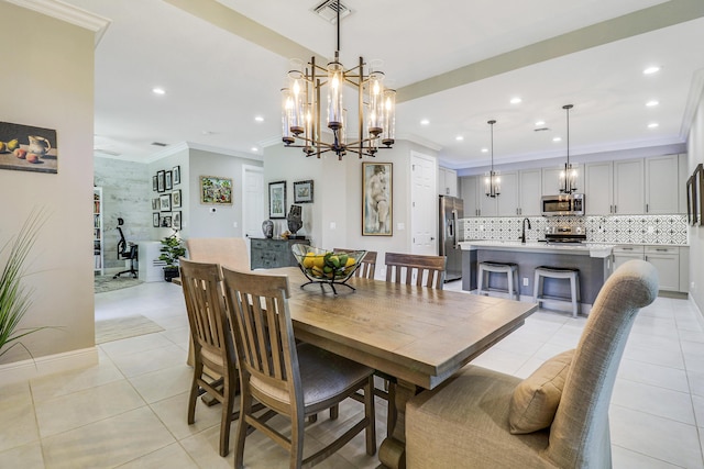 tiled dining space featuring a notable chandelier, ornamental molding, and sink