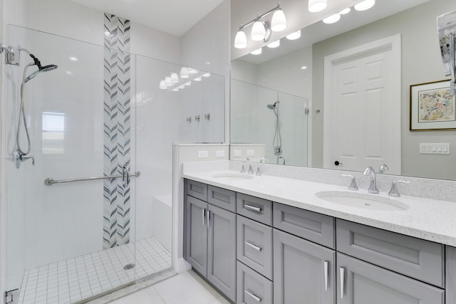 bathroom with tile patterned flooring, vanity, and walk in shower