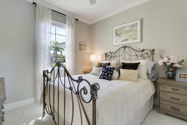 tiled bedroom with ensuite bathroom, ceiling fan, and ornamental molding