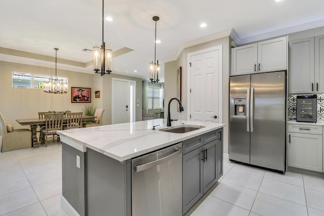 kitchen featuring appliances with stainless steel finishes, gray cabinets, and sink