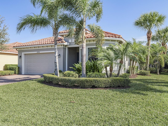 mediterranean / spanish-style home with a garage and a front lawn