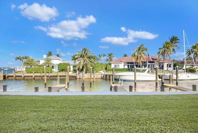 dock area with a lawn and a water view