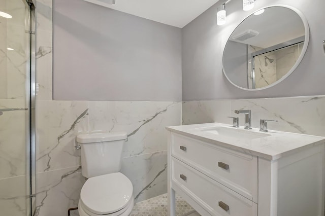 bathroom featuring vanity, toilet, tile walls, and walk in shower