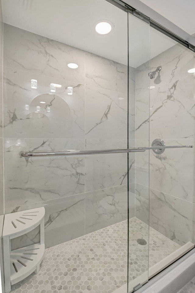 bathroom with a shower with shower door