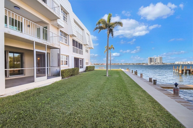 view of yard featuring a boat dock and a water view