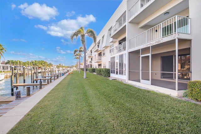 exterior space with a water view and a yard