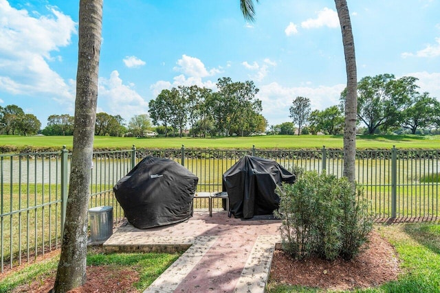 view of patio / terrace with a grill and a water view