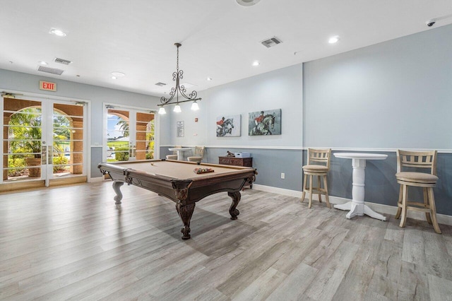 recreation room with light hardwood / wood-style flooring, billiards, and french doors