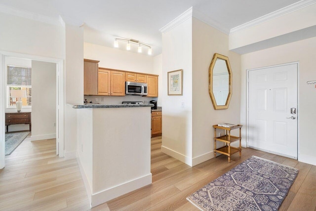 kitchen with light wood-type flooring and crown molding