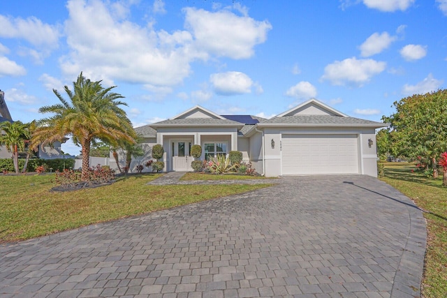 single story home with a garage and a front lawn