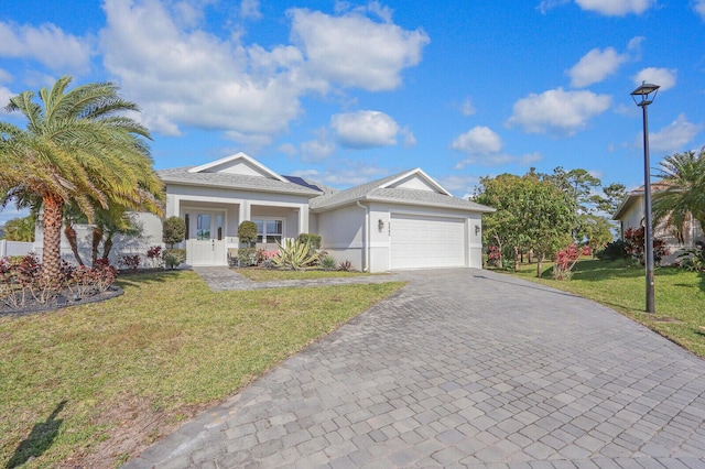 view of front of property featuring a front yard, a porch, and a garage