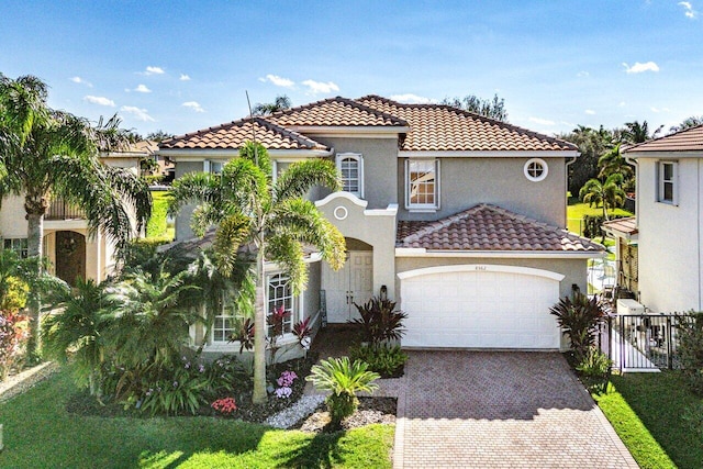 mediterranean / spanish-style home featuring a garage