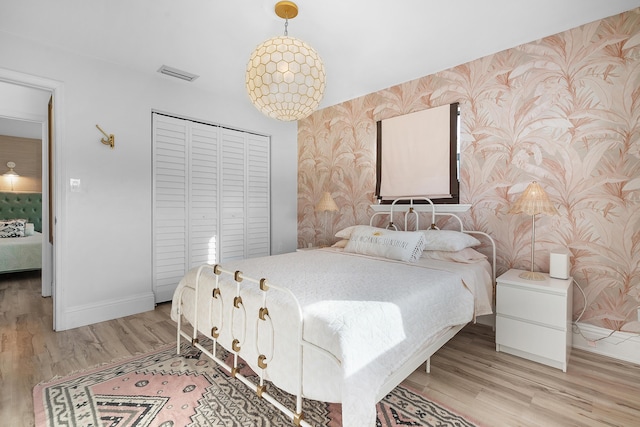 bedroom featuring light hardwood / wood-style flooring and a closet