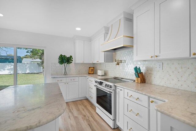 kitchen featuring white cabinetry, white range with electric cooktop, stainless steel dishwasher, light stone counters, and custom exhaust hood