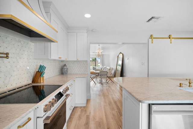 kitchen featuring an island with sink, white cabinetry, stainless steel appliances, and custom exhaust hood