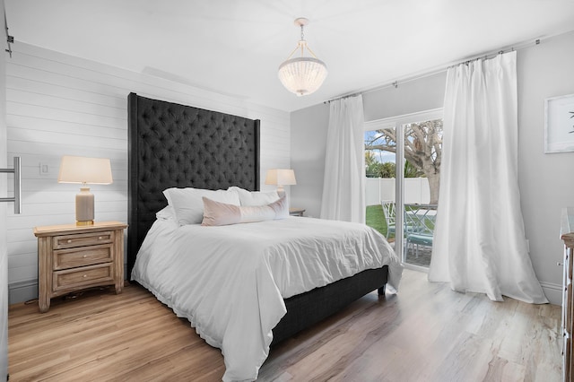 bedroom featuring access to outside and light hardwood / wood-style floors