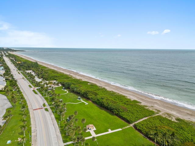 drone / aerial view featuring a water view and a beach view