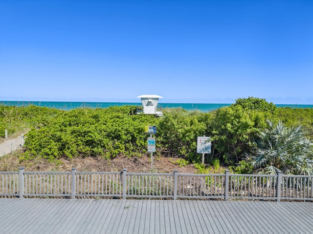 wooden terrace featuring a water view