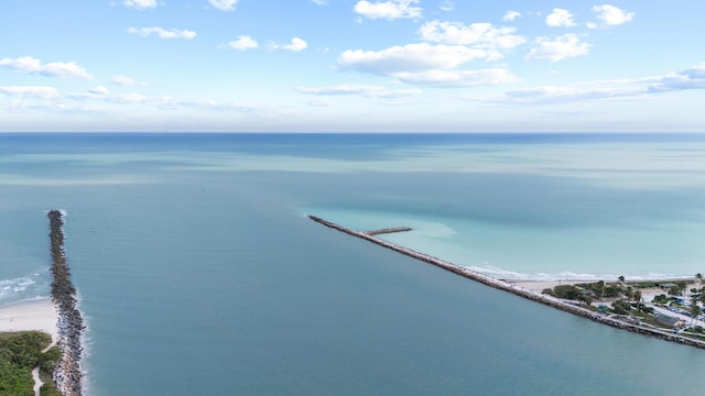 birds eye view of property with a water view and a beach view