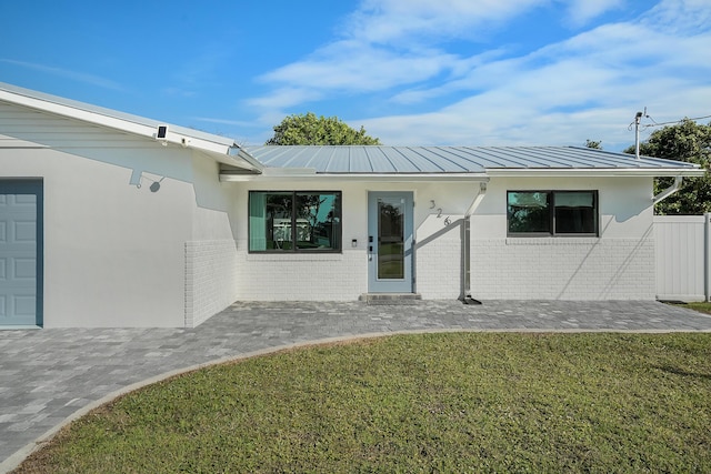 doorway to property with a yard