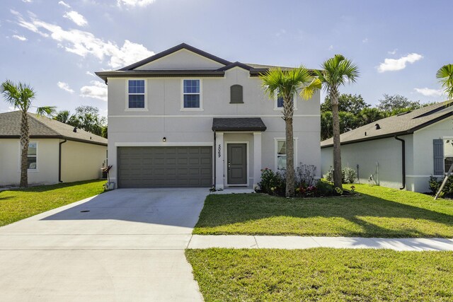 view of front property with a garage and a front yard