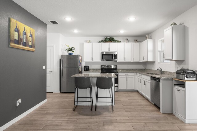 dining room featuring light hardwood / wood-style floors and sink