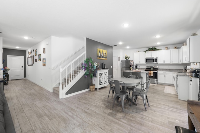 dining space featuring light hardwood / wood-style floors and sink