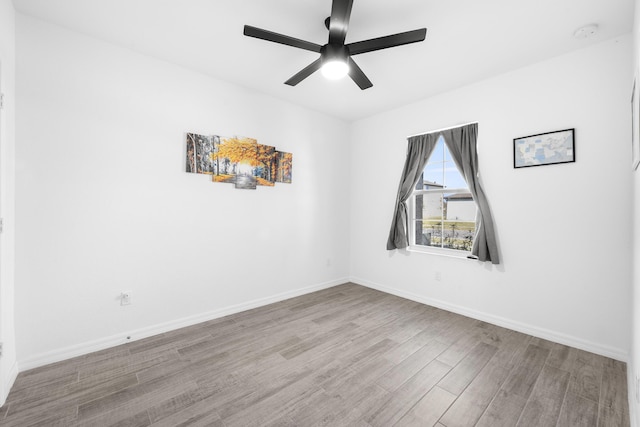 spare room featuring ceiling fan and wood-type flooring