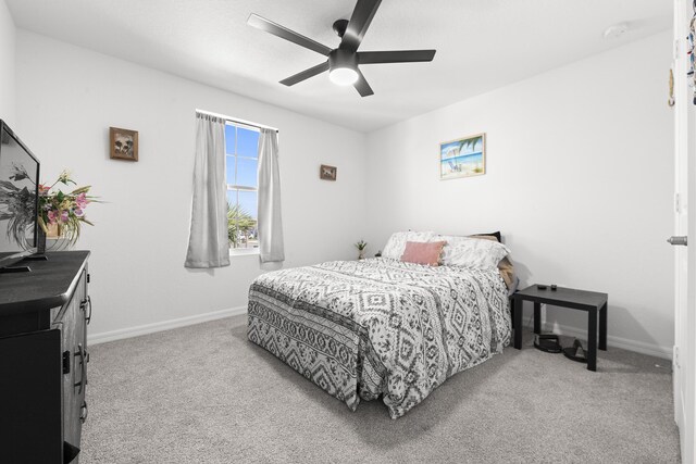 bedroom with ceiling fan and light carpet