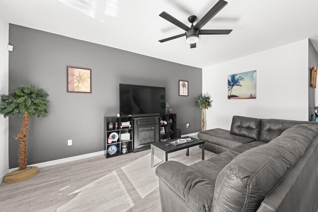 living room with ceiling fan and light hardwood / wood-style floors