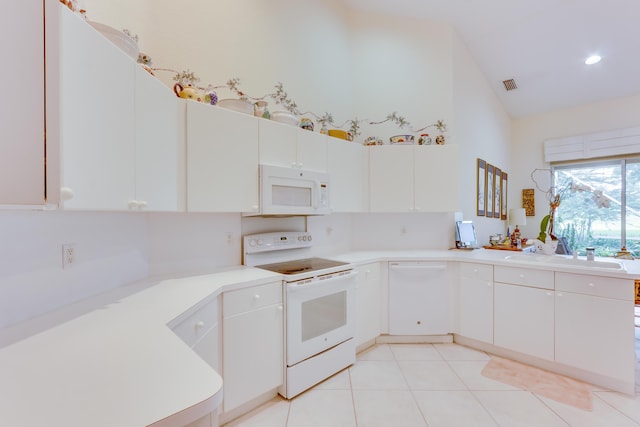 kitchen featuring white cabinetry, white appliances, sink, and light tile patterned floors