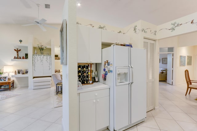 kitchen featuring white cabinetry, light tile patterned floors, white refrigerator with ice dispenser, and ceiling fan