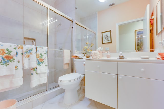 bathroom with vanity, toilet, an enclosed shower, and tile patterned flooring