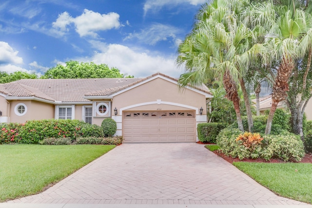 view of front of home with a garage and a front yard