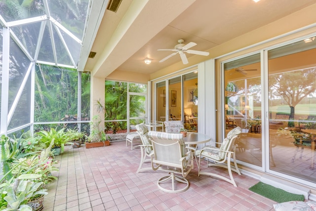 sunroom / solarium featuring plenty of natural light and ceiling fan