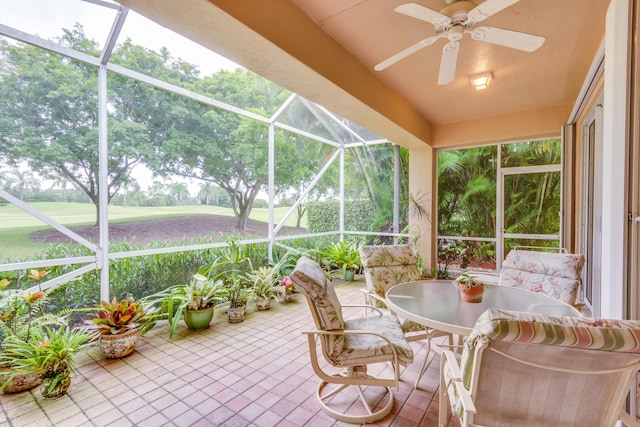 sunroom featuring ceiling fan