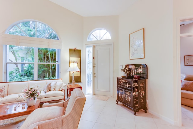 tiled living room featuring a towering ceiling