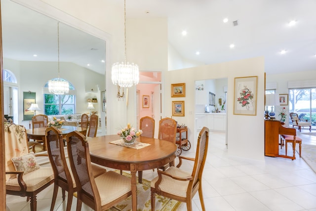 tiled dining room with high vaulted ceiling and an inviting chandelier